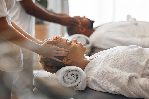 Couple, massage and relax being peaceful, calm and enjoy retreat spa treatment for stress relief. Man, woman and with massage therapist for wellness, stress free together and quality time together.