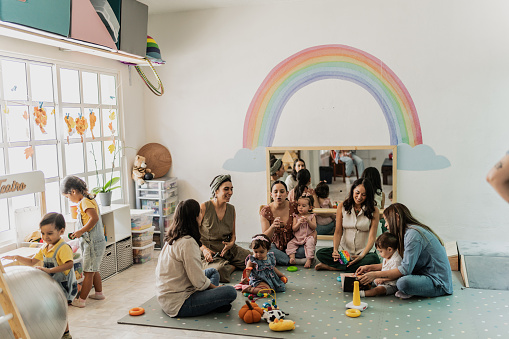 Mothers talking in a support group at playroom