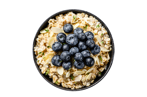 Breakfast oatmeal with  blueberries and almonds.  Isolated, white background