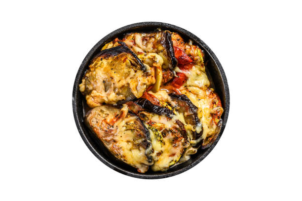 Vegetable ratatouille baked in cast-iron dish.  Isolated, white background