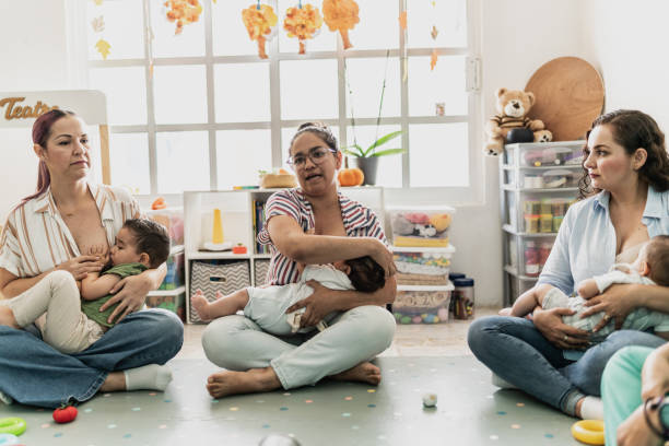 istock Young mother breastfeeding her baby while talking with other mothers in support group 1798259222