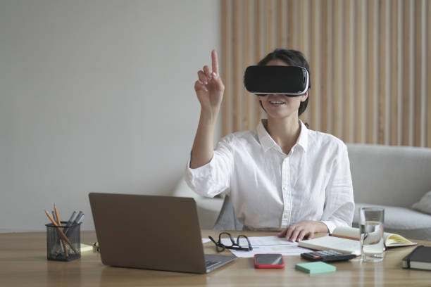 istock Engaged female professional using VR headset in modern home office setup 1798270359