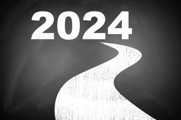 istock happy new year：the way to 2024 on blackboard with clock 1798271175
