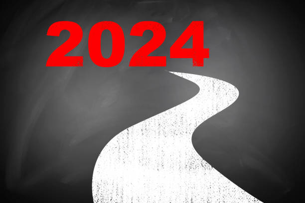 istock happy new year：the way to 2024 on blackboard with clock 1798271182