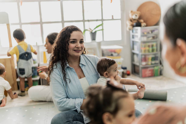 istock Mother talking while holding her son in the playroom 1798282080
