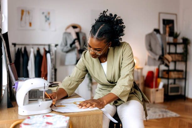 istock Young well dressed woman designing clothes at her small tailor workshop 1798284342