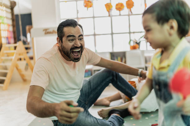 Father playing with his son in the playroom