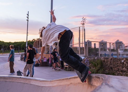 Barcelona, Spain – November 15, 2023: Skateboarder doing a trick in a skate park in Barcelona, Spain