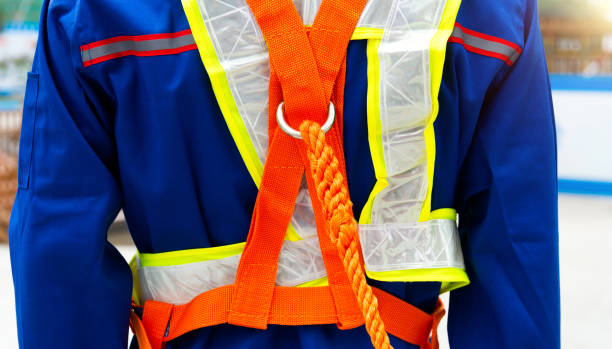 Rear view of construction site worker with safety rope