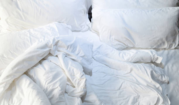 istock Top view of messy bedding sheets and pillow 1798300909