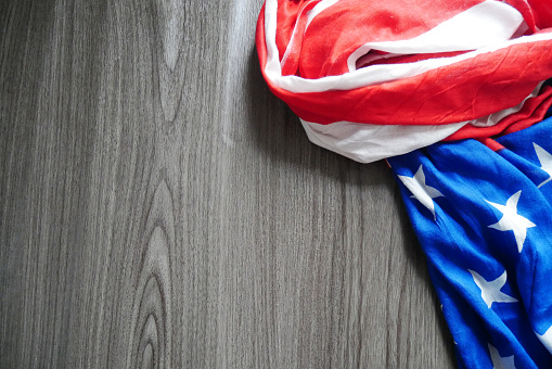 Closeup of an American flag on wooden texture background. Similar image from my portfolio. Copy space