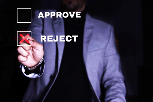 Businessman checking the reject box. Concept of rejection, disagreement.