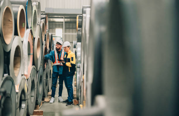 istock Metal sheet workers perform routine quality checking, enhancing assurance in roofing infrastructure 1798327074