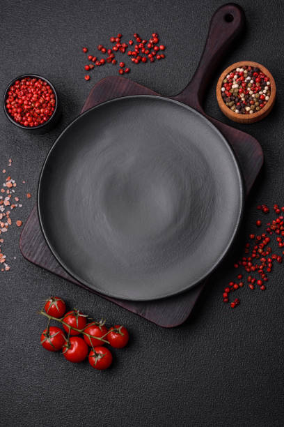 istock Empty plate, wooden cutting board with salt and spices 1798338009