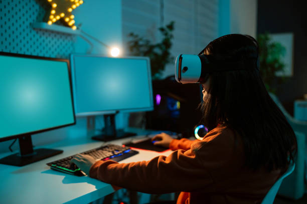 istock Unrecognizable female gamer Asian ethnicity wear VR headset while playing video game on PC 1798338930
