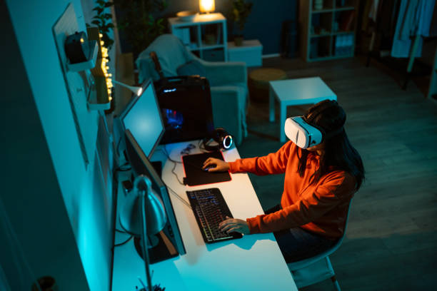 istock Female gamer Asian ethnicity wear VR headset while playing video game on PC 1798339080