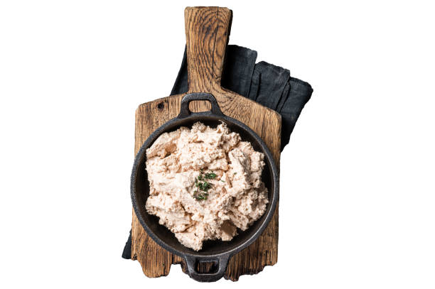 istock Cod liver Spread with oil in a skillet.  Isolated, white background. 1798342962
