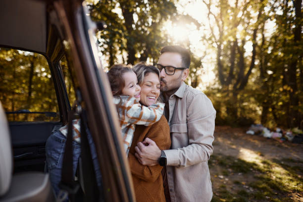 istock Affectionate family enjoying at camper trailer in nature. 1798352124