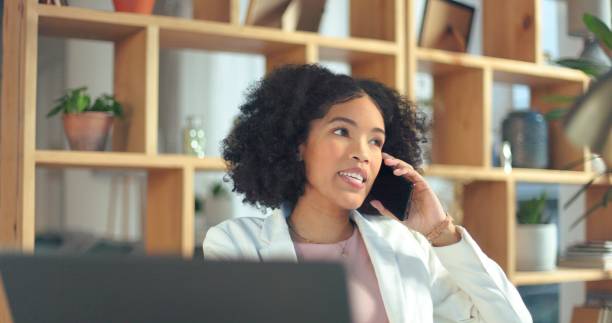 istock Phone call, remote work and a freelance woman in her home office for communication or networking. Contact, small business startup and young entrepreneur talking on her mobile for planning or strategy 1798356437