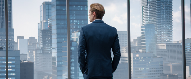 Shot of a mature businessman looking thoughtfully out of an office window