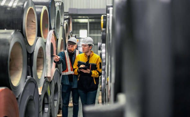 istock Metal sheet workers perform routine quality checking, enhancing assurance in roofing infrastructure 1798372223