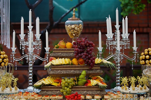 Sweet table candy bar on a holiday in honor of a wedding or children 's holiday. Assortment of sweets and desserts.