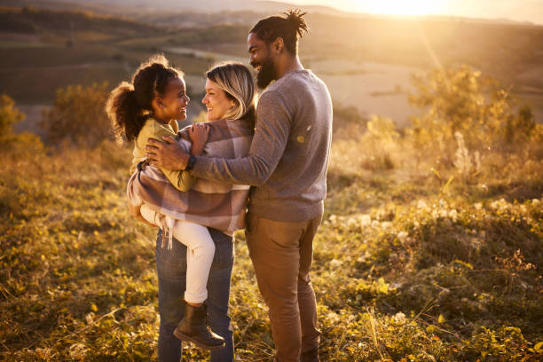 istock Happy diverse family talking while spending an autumn day in nature at sunset. 1798382918