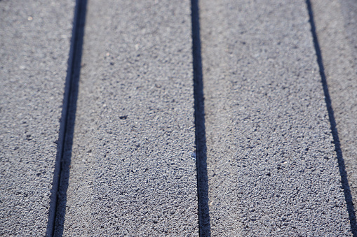 Pellet-stacked gray concrete curb. The texture of vibropressed concrete products.