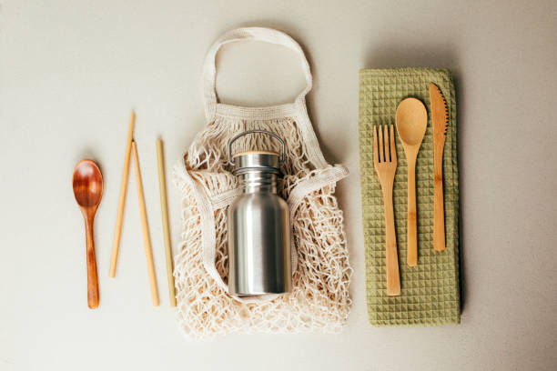 istock Different fabric bags for storage on a gray background. Eco bags for multiple use. A reusable straws, wooden cutlery 1798387722