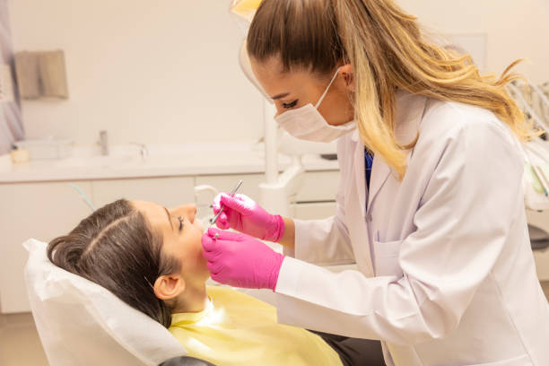 istock Young woman having routine check-ups at the dentist. A modern dental office. 1798401937