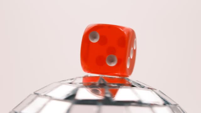 red dice on globe with mirrors spinning on neutral  background