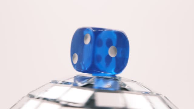 blue dice on globe with mirrors spinning on neutral  background