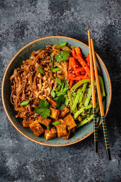 istock Soba noodles with vegetables and fried tofu in a bowl. 1798409708