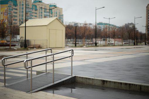 Comfortable environment for people with disabilities. Handrail on the square. Barrier-free urban environment. City square.