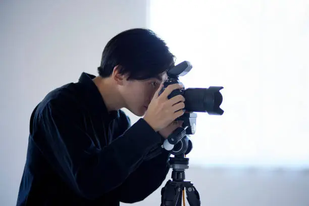 Japanese male photographer working in a photo studio