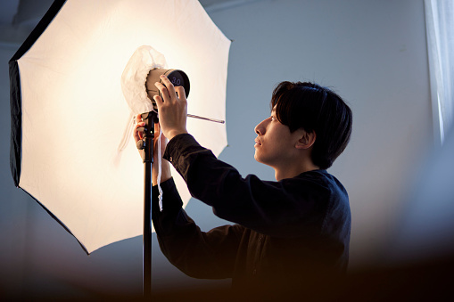Japanese male photographer working in a photo studio