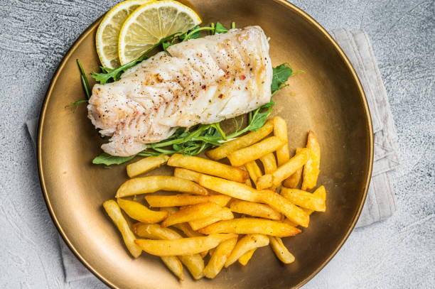 istock Fried cod fish fillet served with french fries. White background. Top view 1798442490