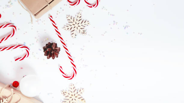 istock Christmas composition with gift boxes, candy cane, gingerbread, snowflakes on a white background. 1798442650