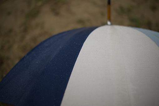 Rain drops falling on an umbrella