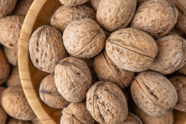 istock Walnut in shell. Background view from above. Healthy food bowl top view. 1798450733
