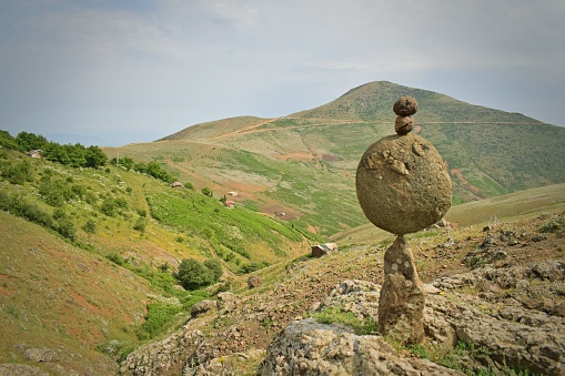 The balanced rocks against the backdrop of mountains