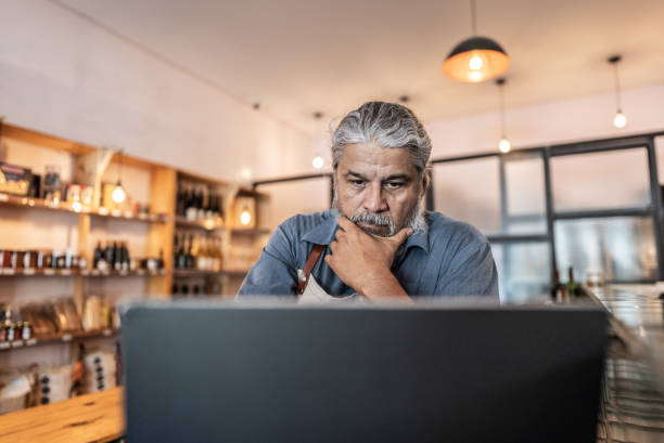 Worried business owner using laptop