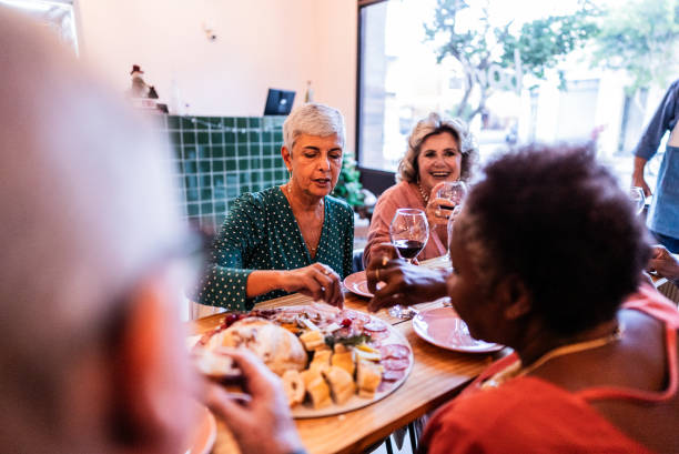 istock Happy friends eating and drinking wine at a restaurant 1798486362