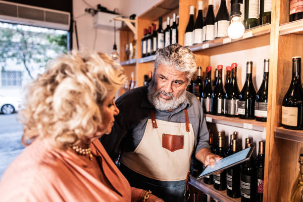 istock Salesman helping customer in a liquor store 1798486882