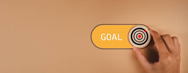 istock Target goal success and business objective focus on grow concept. Hand switch Target with arrow icon to goal excellence on orange background , Business plan purpose challenge. 1798488515