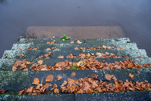 Old stone stairs lead down to Black river Orebro Sweden November 14 2023