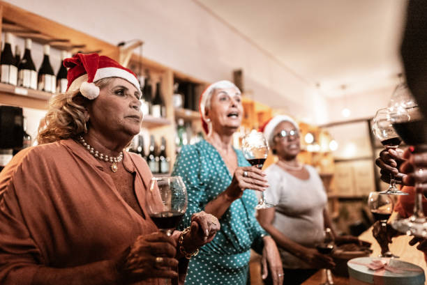 istock Senior friends talking while hold wine glass at christmas 1798494140