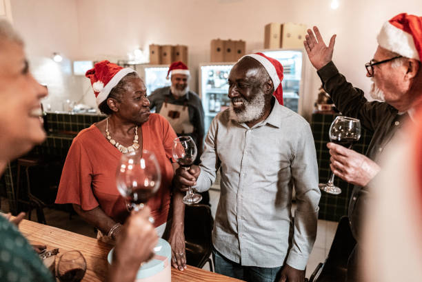 istock Senior friends talking while hold wine glass at christmas 1798494483