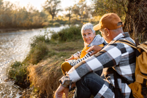 istock Senior couple enjoying sunset by the river 1798496157