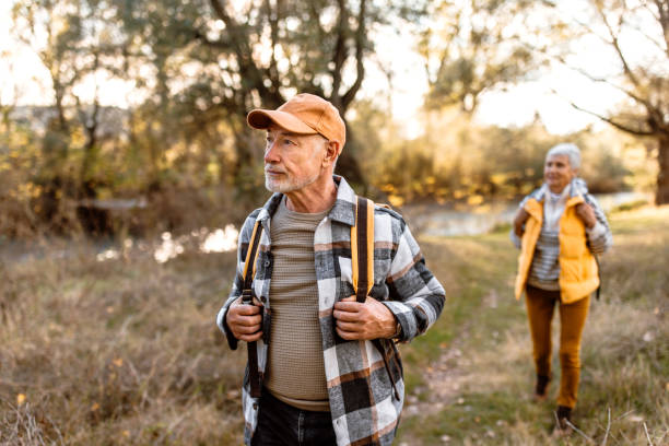 istock Senior hikers enjoying walk by the river on a sunny autumn day 1798500029
